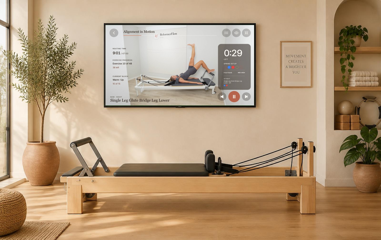 ReformerFlow landscape player shown on a TV in a Pilates studio